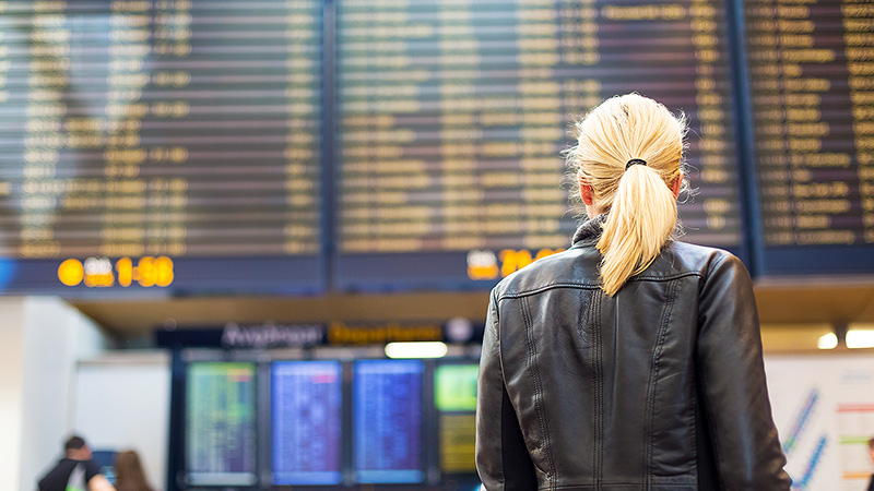 Marquee-VE-GirlAtTheAirport-800x450 Woman at an airport looking up at the flight timetable.