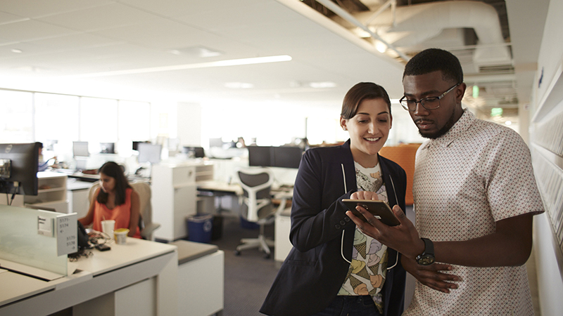 Man and woman looking at a tablet